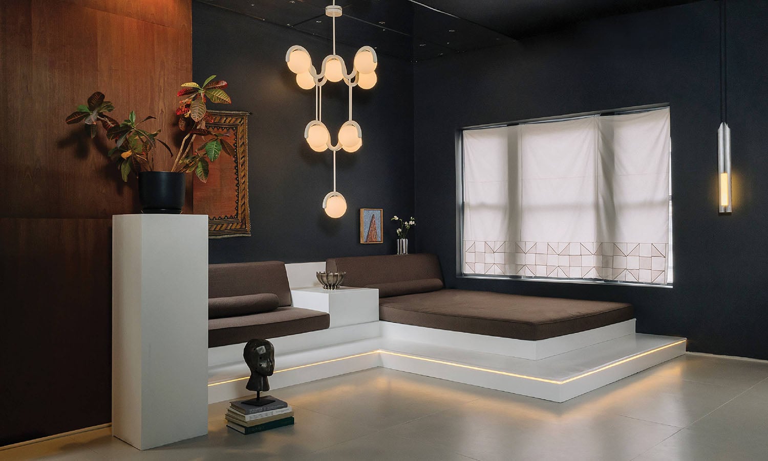 A living room with a couch and a lamp.