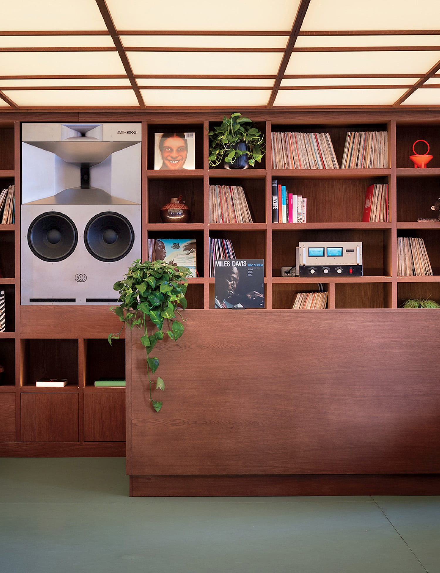 "A room with a desk, bookshel, and a tv"