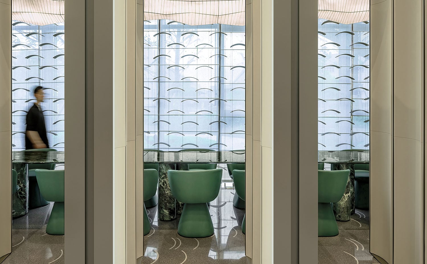 A woman walking through a glass door.