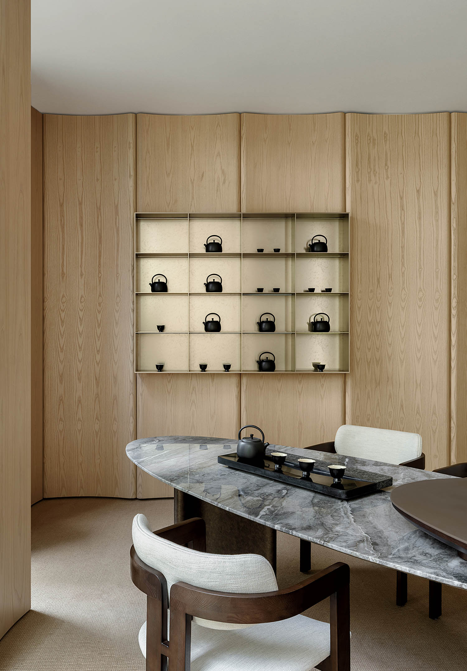 A dining room with a table and chairs.