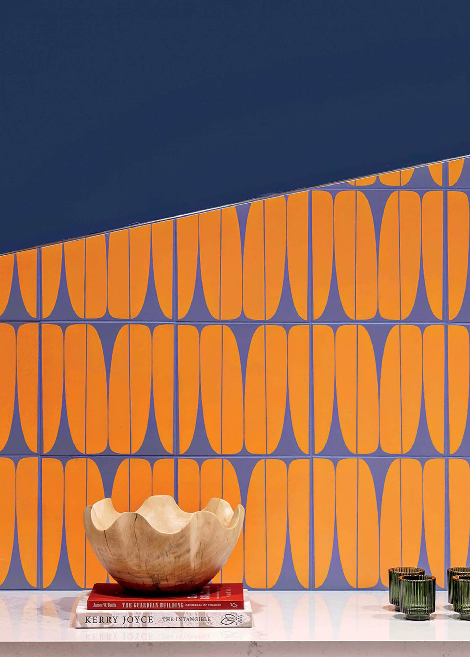 A white table with a vase and a wallpaper.