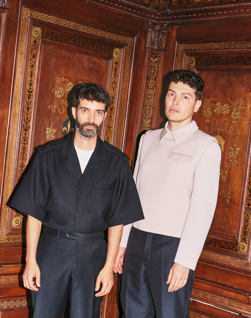 Two men standing next to each other man.