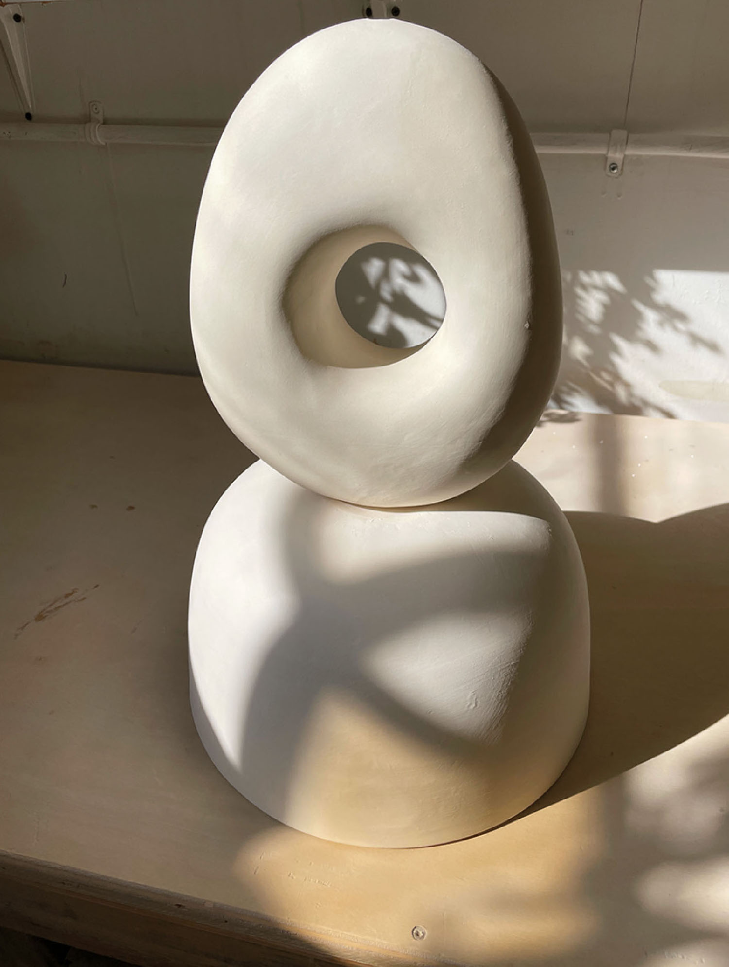 A sculpture of a white object on a table.