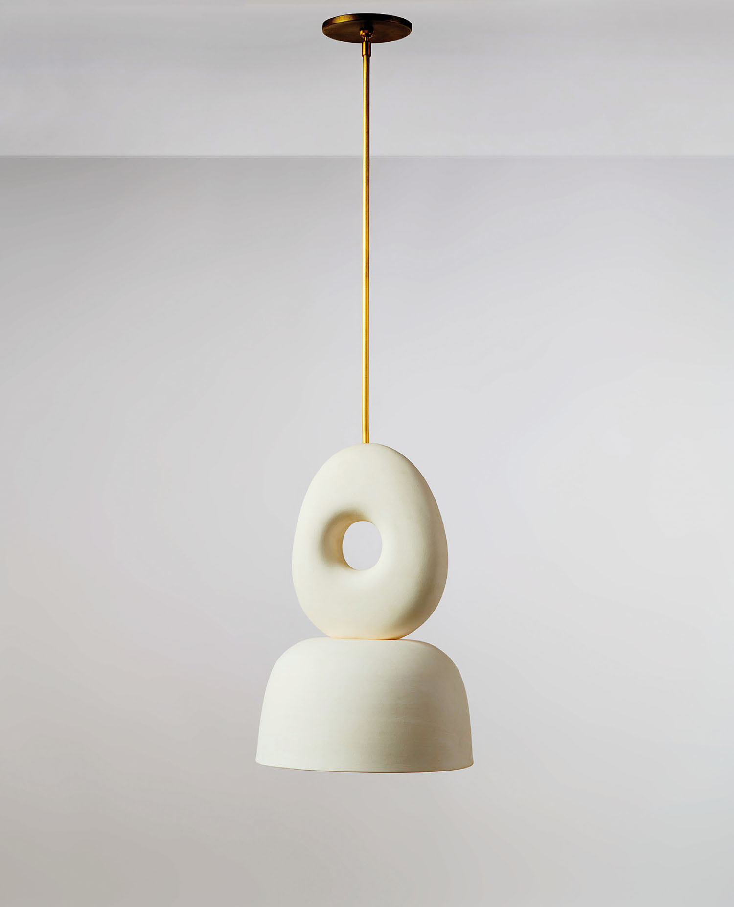 A white lamp hanging from a ceiling.