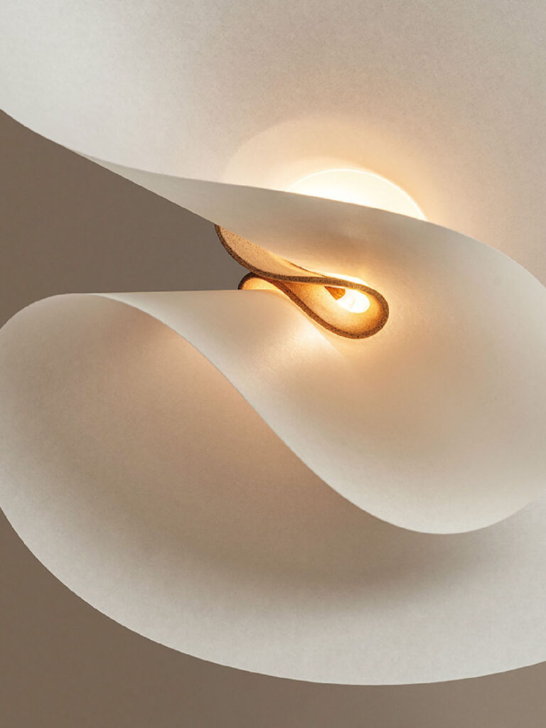 A white ceiling light with a gold ring.