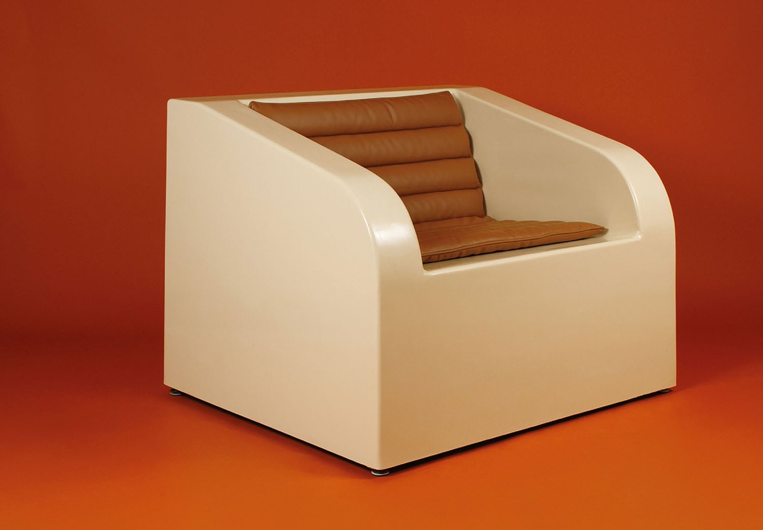 A white chair with a brown cushion.