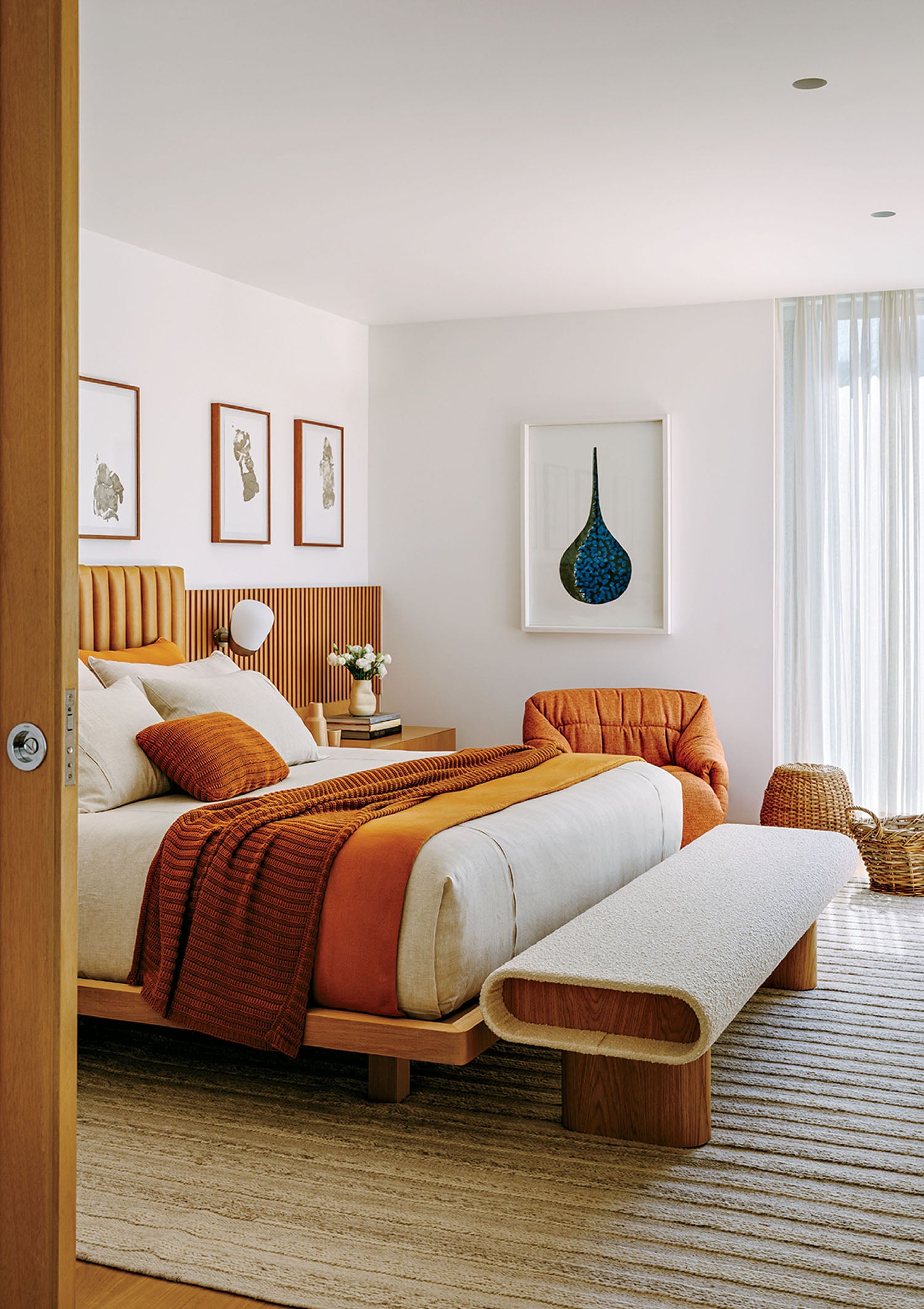 A bedroom with a bed and a chair.