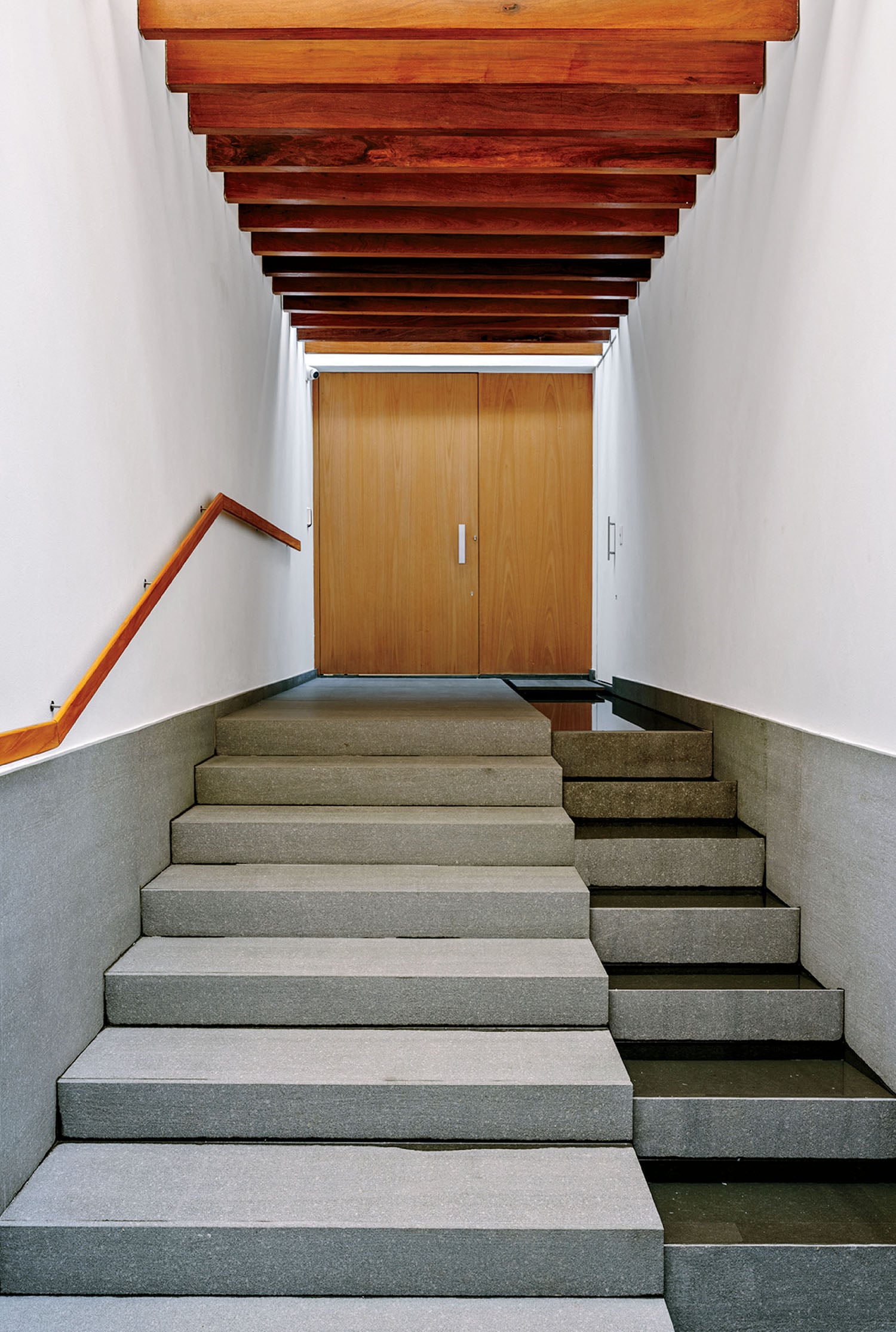 A set of stairs leading up to a wooden door.