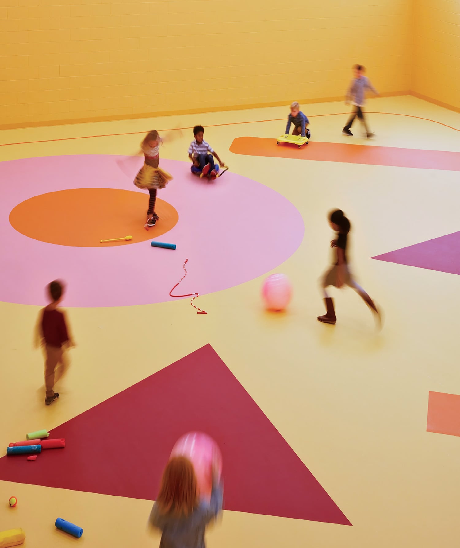 A group of children playing in a room.