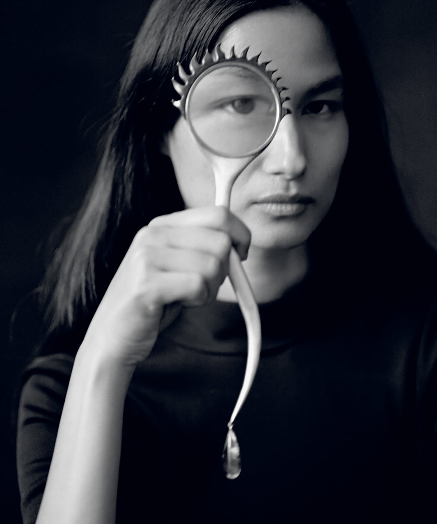 A woman holding a magnifying a magnifying a magnifying a magnify.