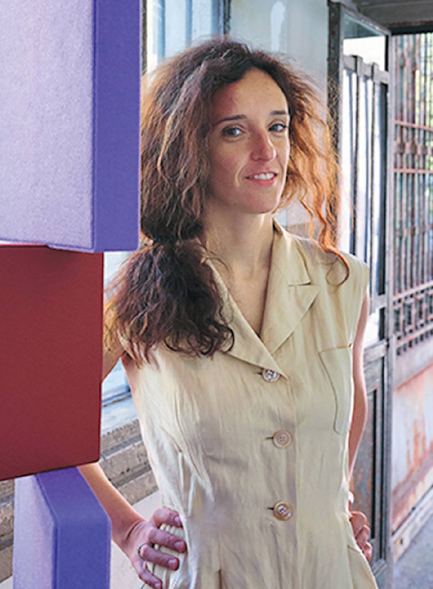 A woman standing in front of a building.