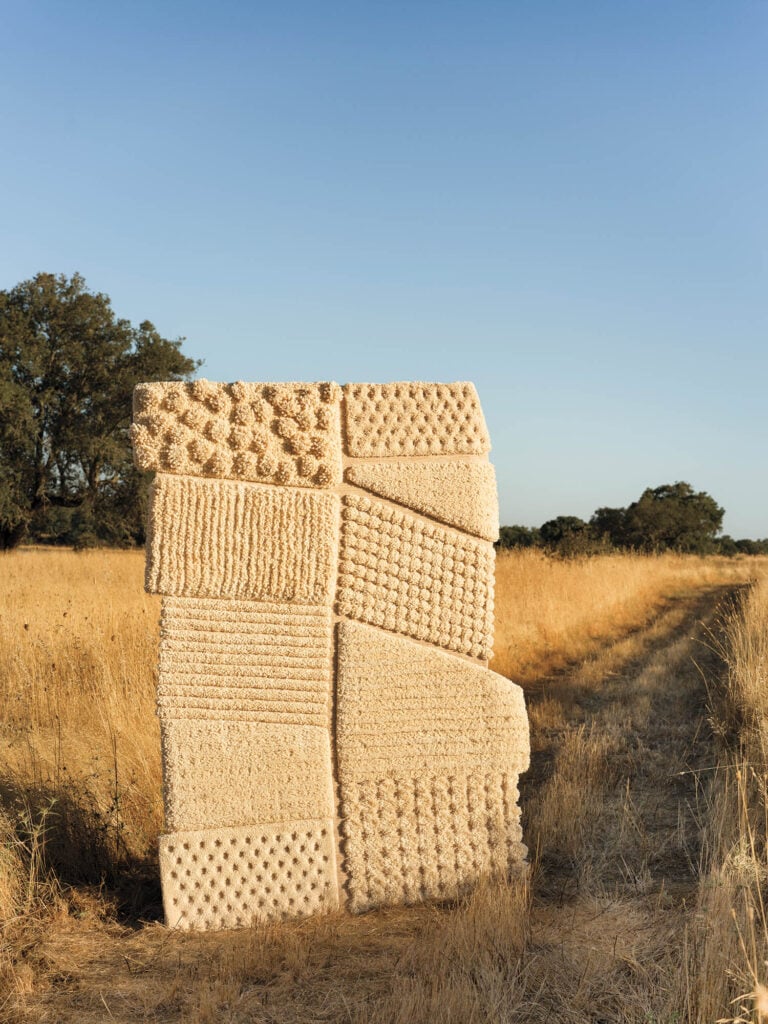 a cream tufted rug with blocks of pattern