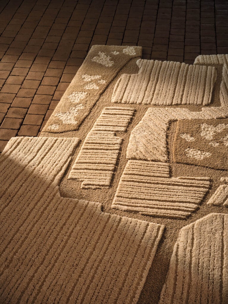 a tufted rug in tan with light streaming in