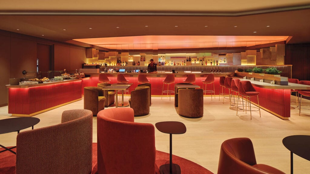 curved red seats in airport lounge