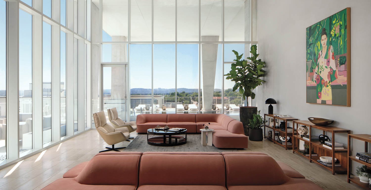 living area with two couches and glass walls