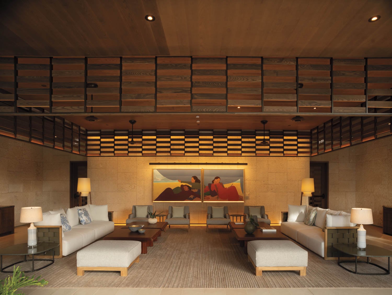 a cozy seating area with art and white couches