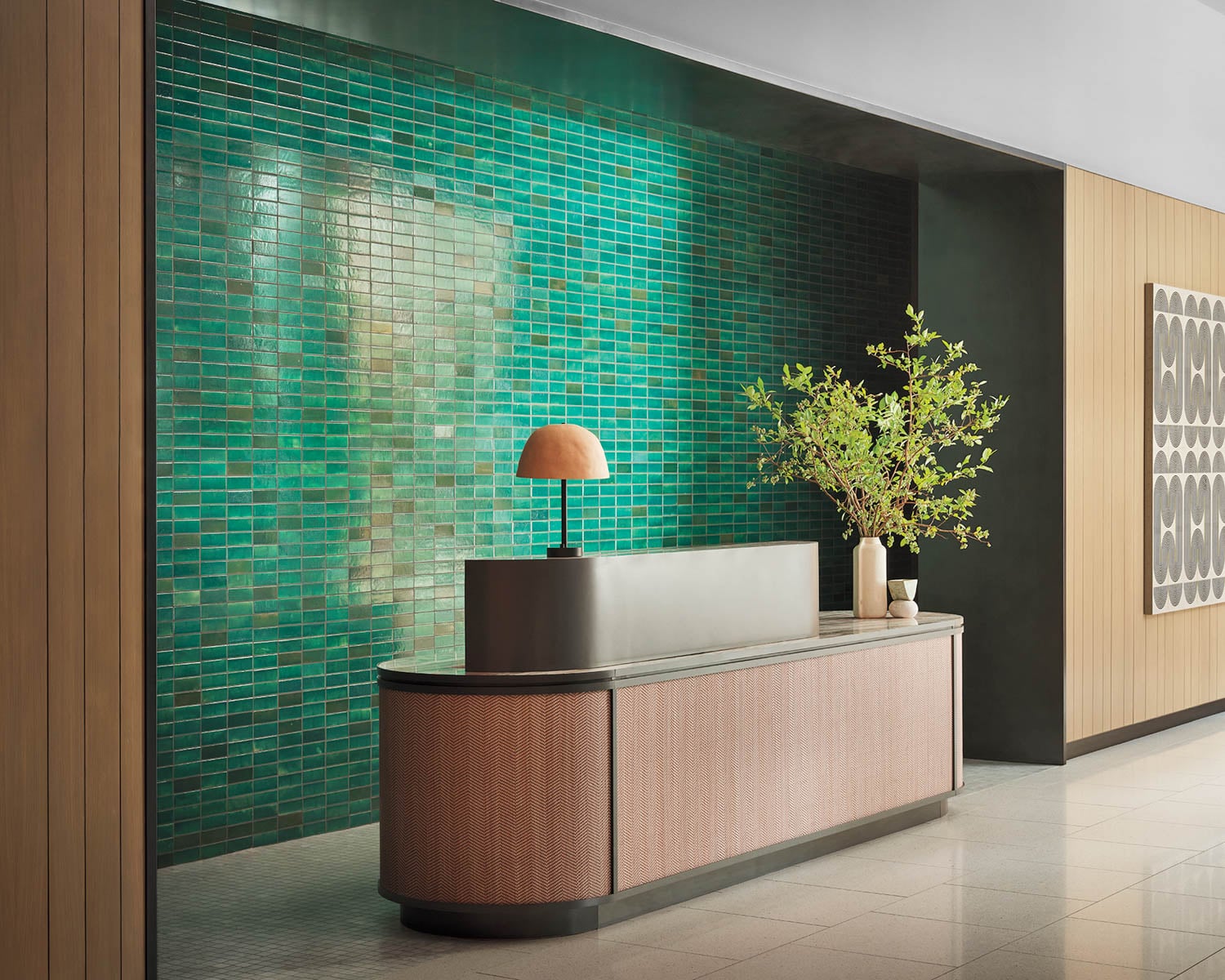 a green tiled wall near a reception desk