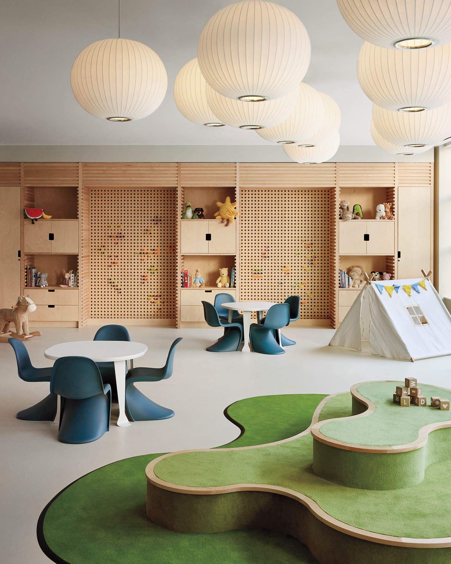 a curved green carpet and play area