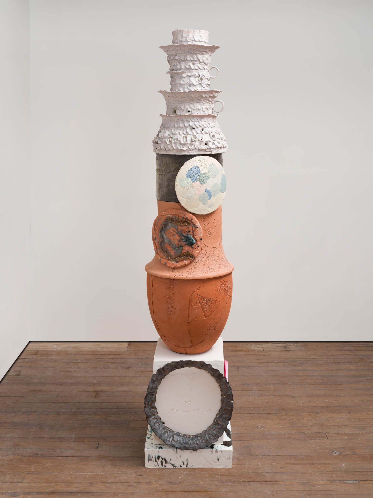 multicolored jar on a white marble stand