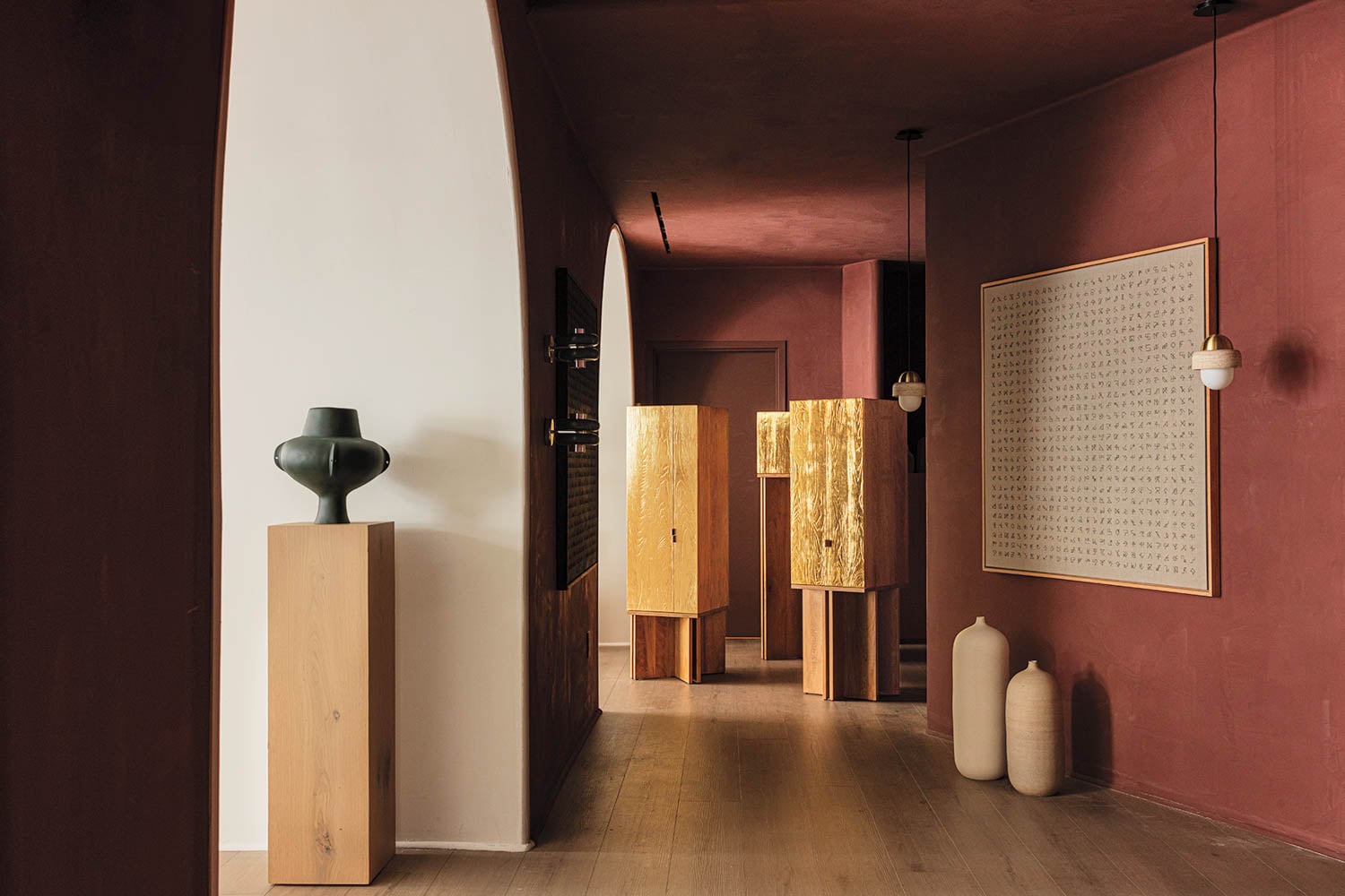 A hallway with a vase and a large painting