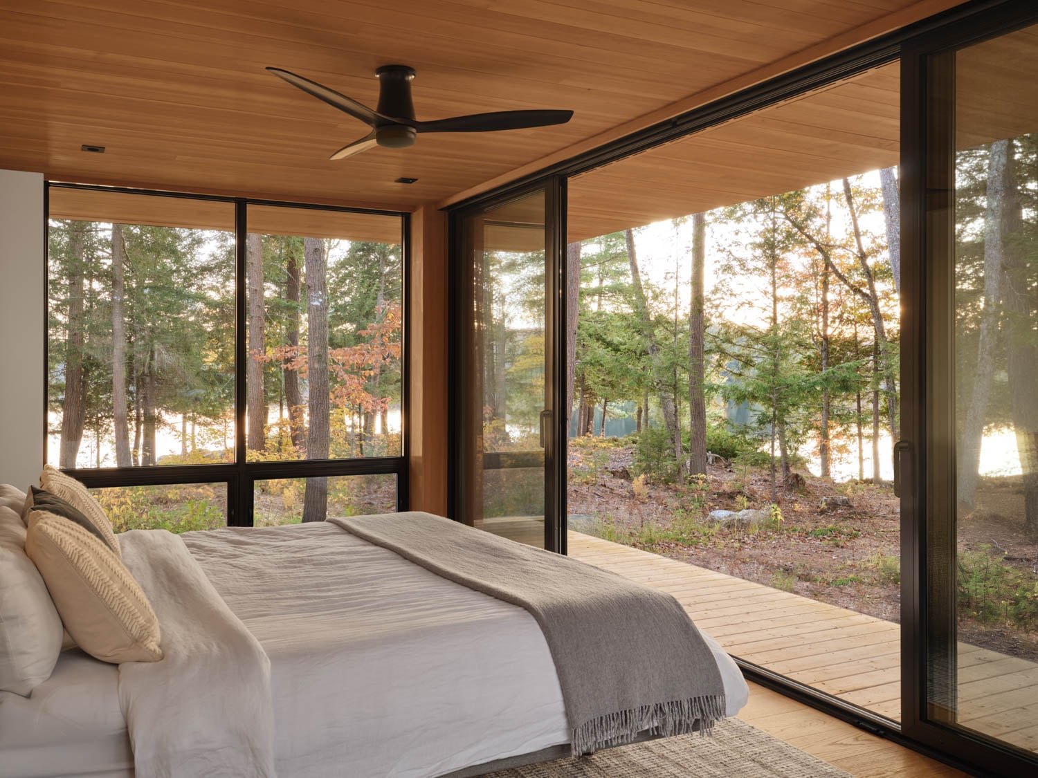 bedroom with floor to glass windows facing surroundings
