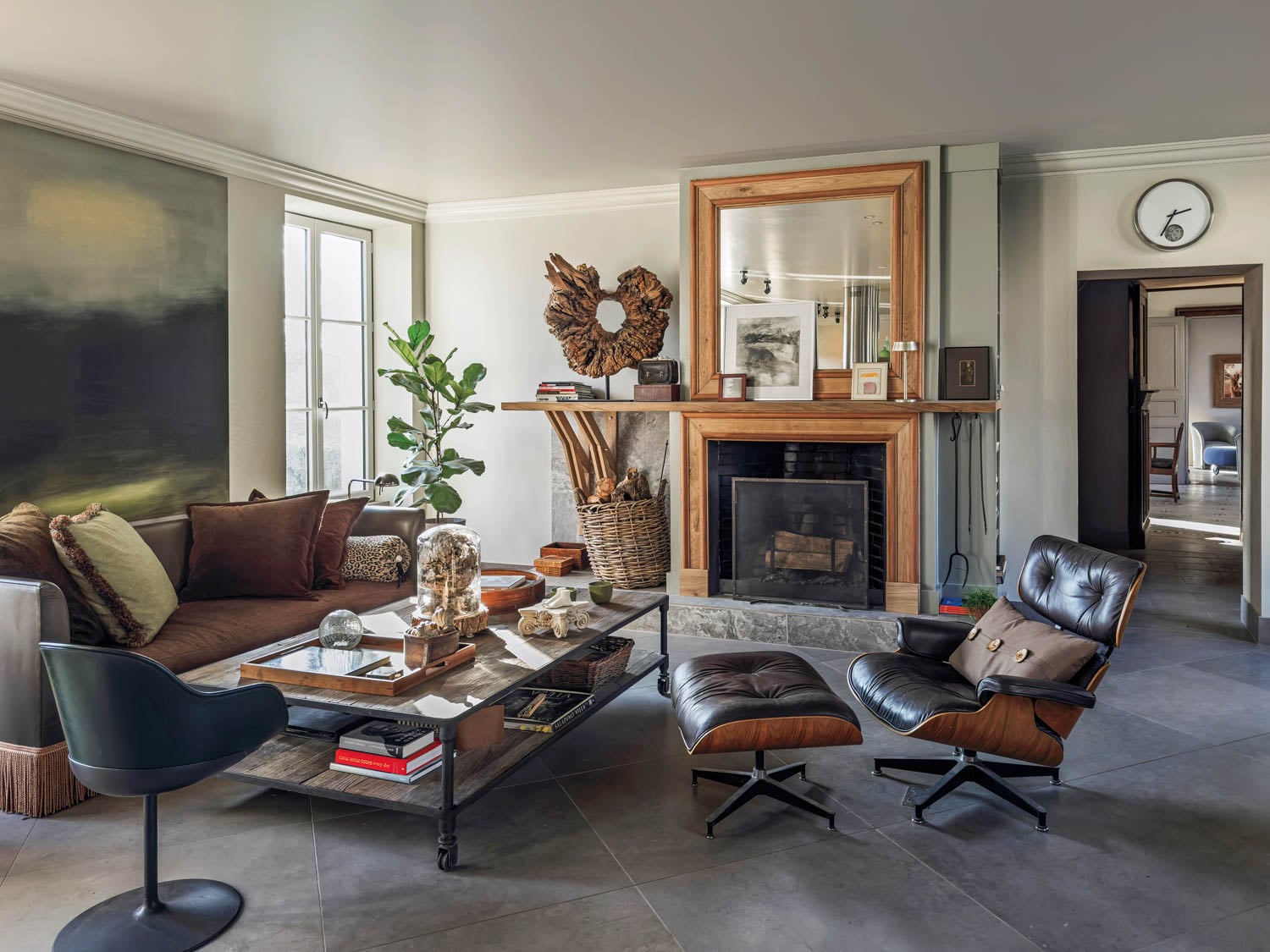 kitchen sitting area with dark furnishings and wooden mantelpiece