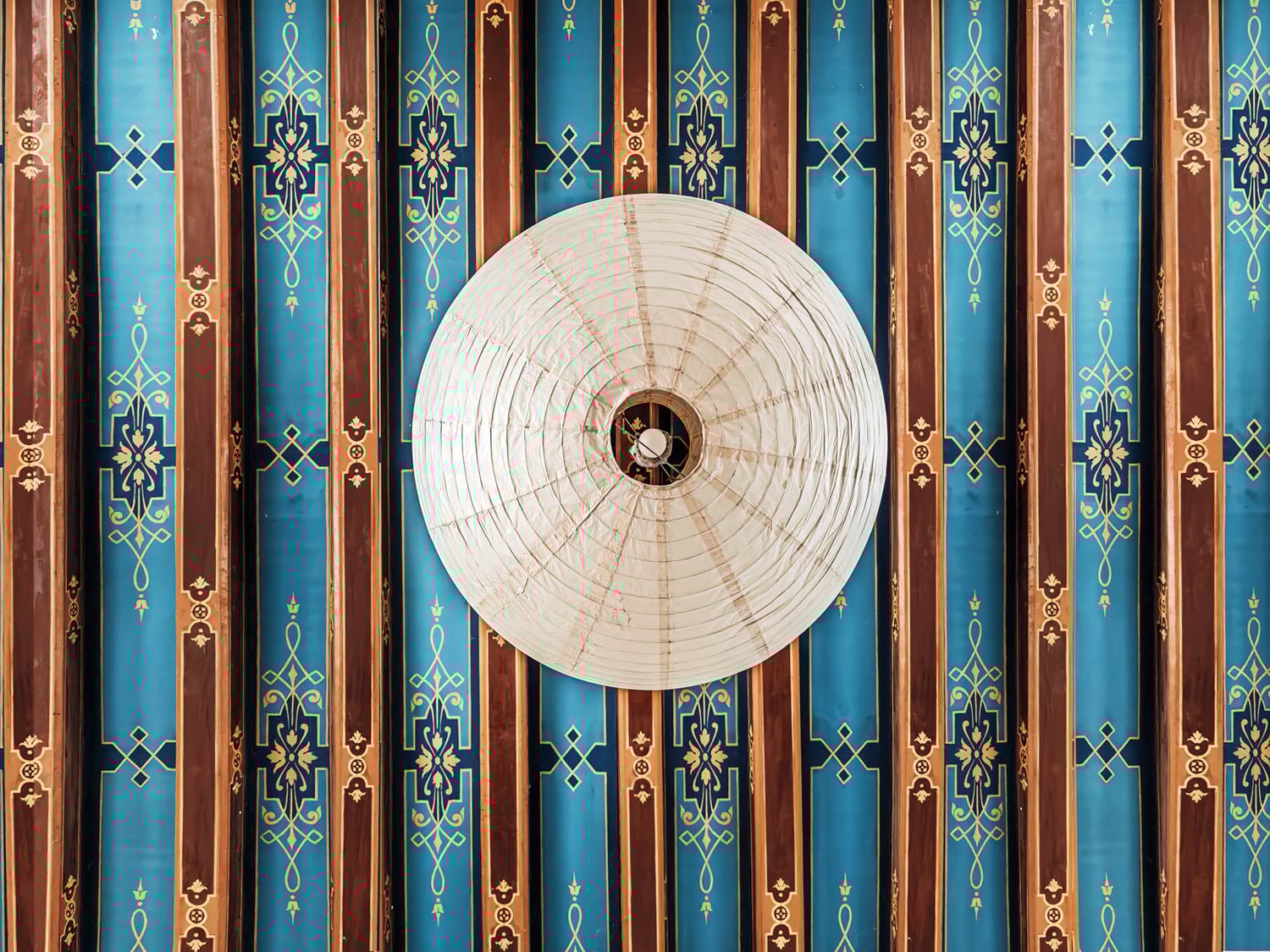 white lantern hanging from blue ceiling