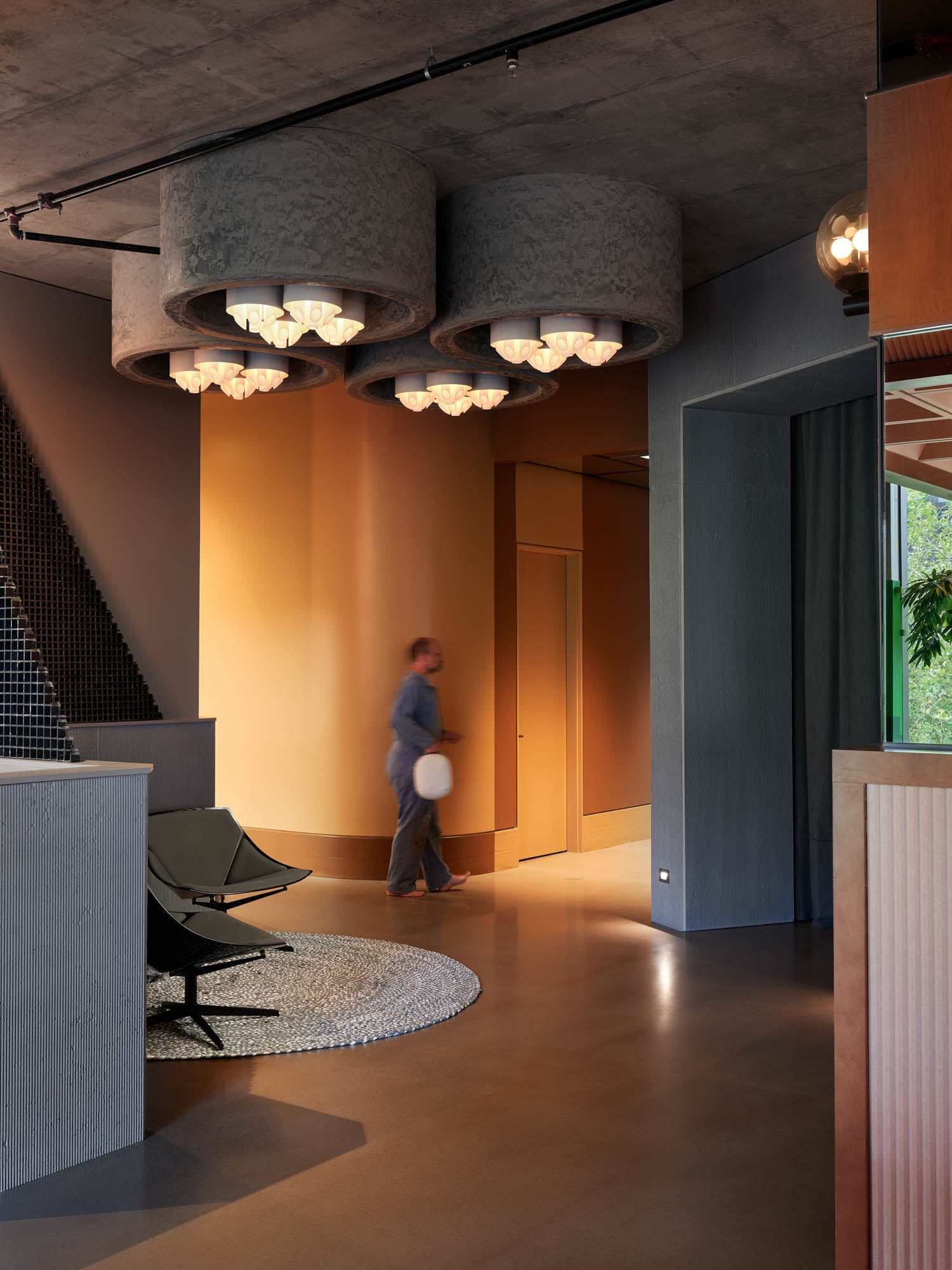 powder coated curved wall leads to the bathrooms