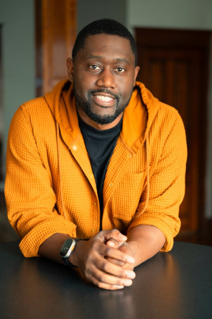 NOMA president Bryan C Lee in an orange hoodie shows of interior design style